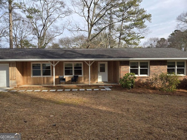 ranch-style home featuring a garage and a porch