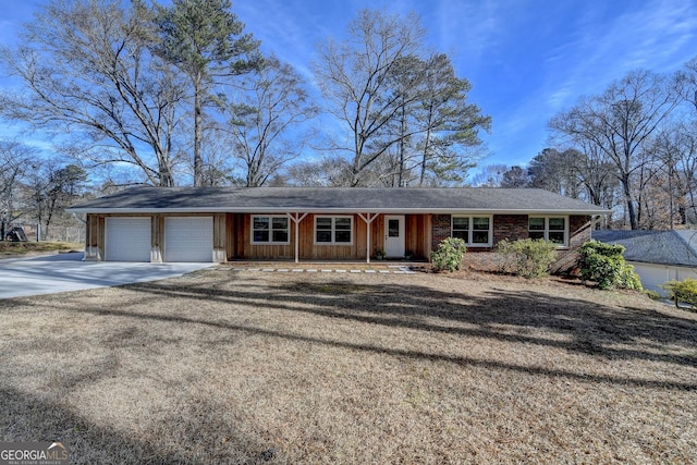 ranch-style house with a garage and covered porch