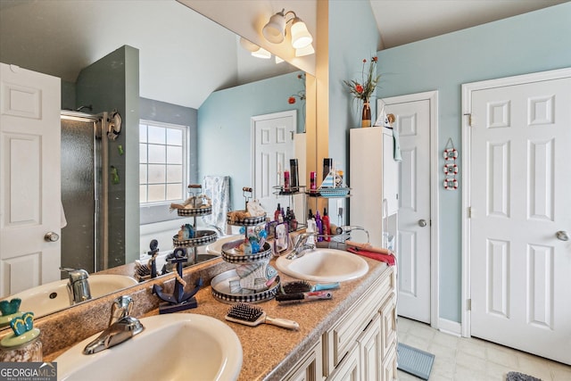 bathroom with lofted ceiling, an enclosed shower, and vanity