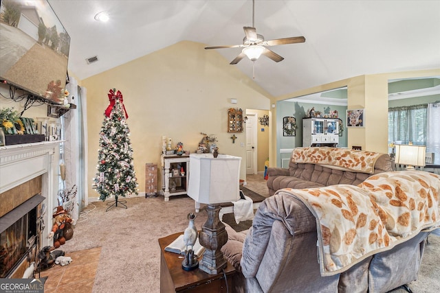 carpeted living room featuring ceiling fan and vaulted ceiling