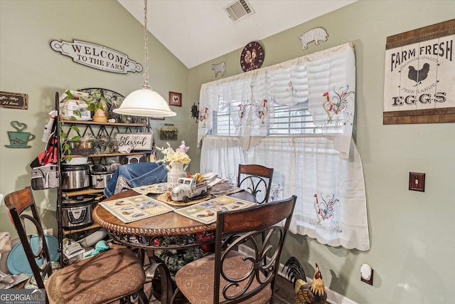 dining room featuring lofted ceiling