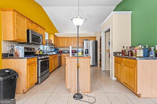 kitchen featuring crown molding, a kitchen island, stainless steel appliances, tasteful backsplash, and light tile patterned flooring