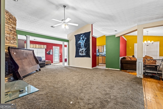 living room with vaulted ceiling, ornamental molding, ceiling fan with notable chandelier, and a textured ceiling