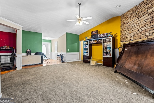 carpeted bedroom with vaulted ceiling and a textured ceiling