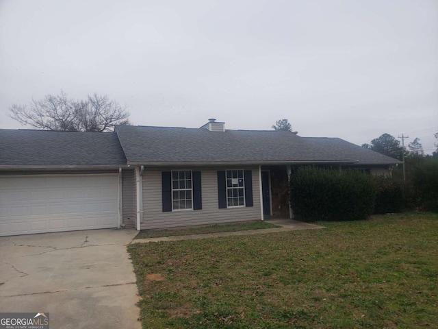 ranch-style house featuring a garage and a front lawn