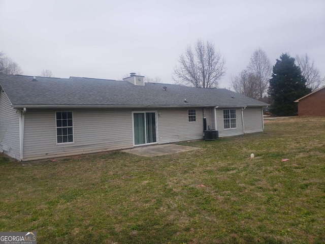 rear view of property with a yard, a patio, and central air condition unit