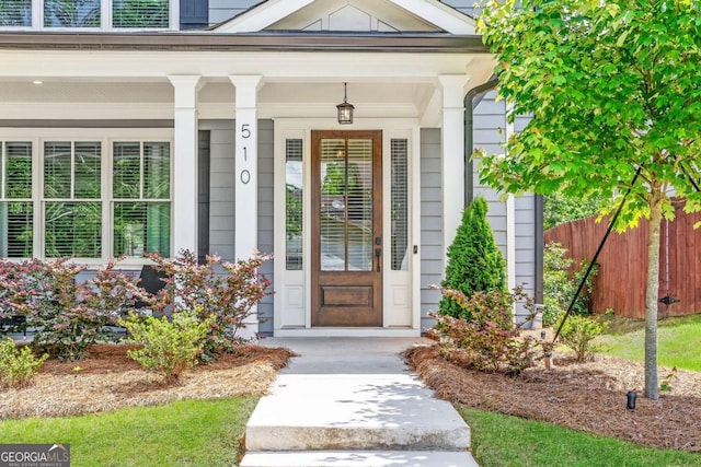 view of exterior entry with covered porch