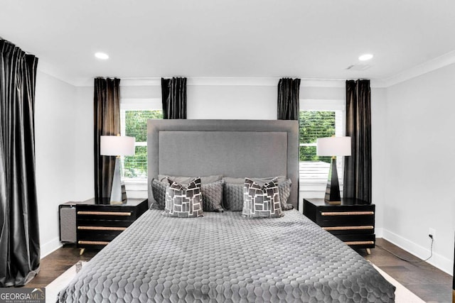 bedroom featuring dark wood-type flooring, ornamental molding, and multiple windows