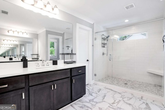 bathroom featuring vanity, ornamental molding, and a shower with door