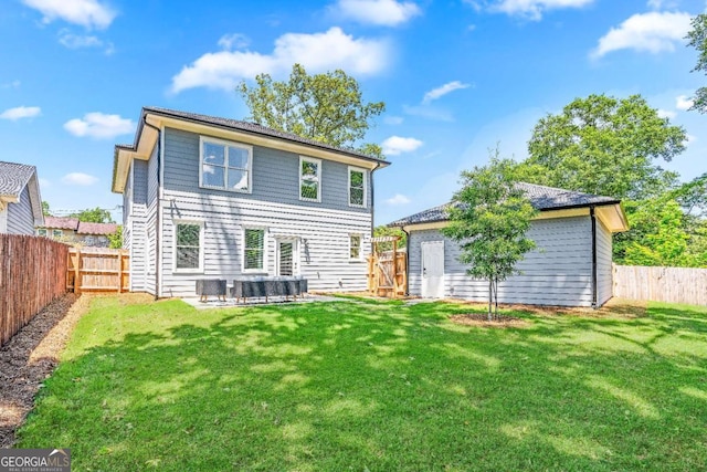 back of house with a yard and a patio