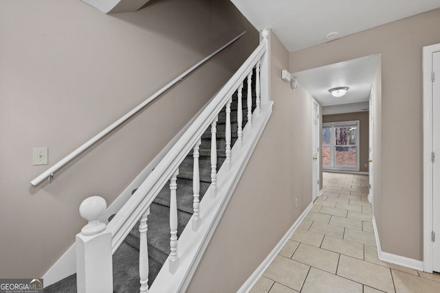 stairway featuring tile patterned flooring