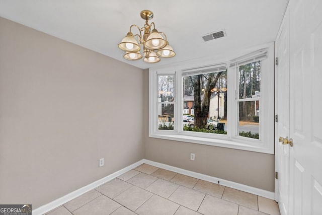 unfurnished dining area with light tile patterned floors and a chandelier