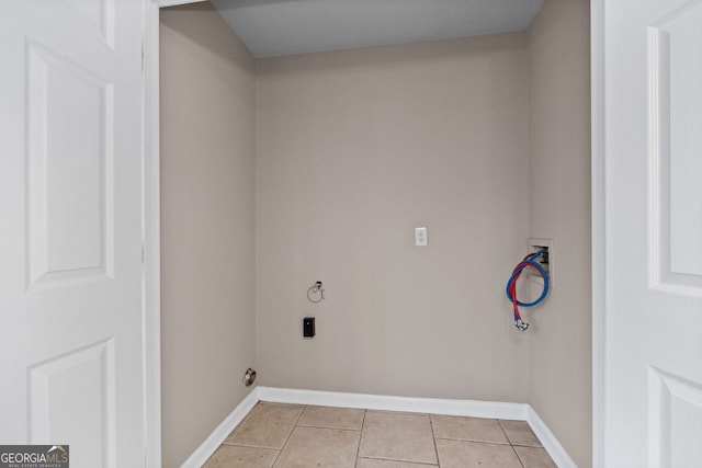 laundry area with electric dryer hookup, washer hookup, and light tile patterned floors