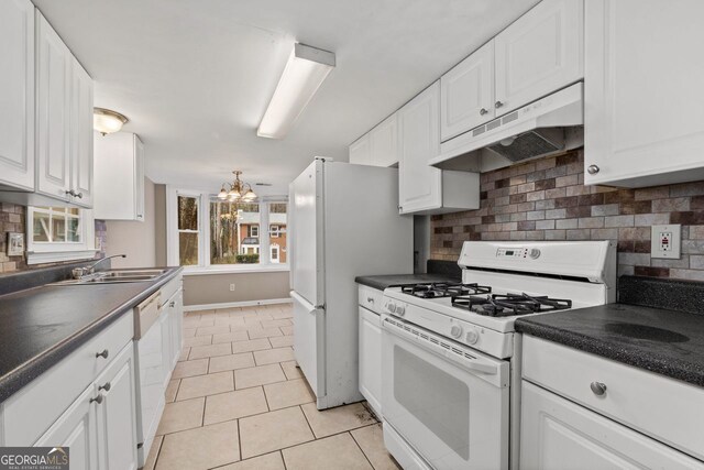 kitchen featuring white cabinetry, tasteful backsplash, a chandelier, light tile patterned floors, and white appliances