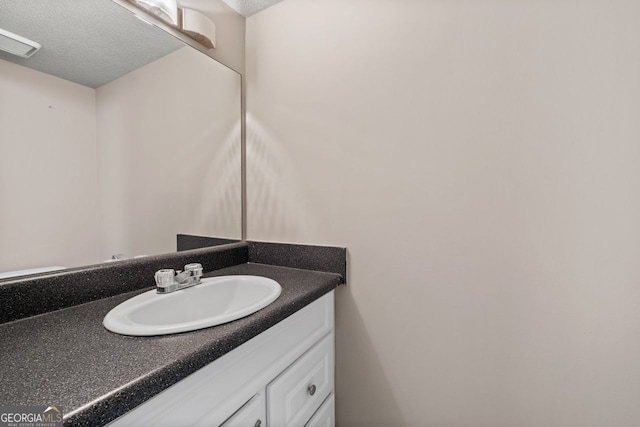 bathroom with vanity and a textured ceiling