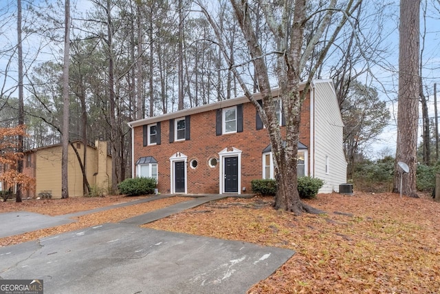 colonial home with central AC unit