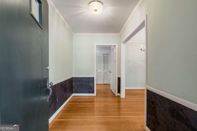 hall featuring ornamental molding and wood-type flooring