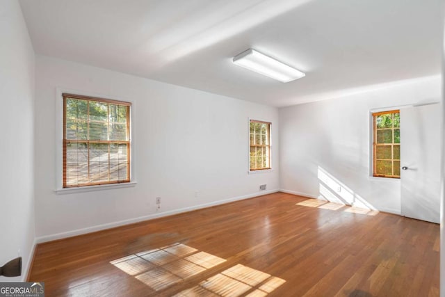 empty room with hardwood / wood-style floors