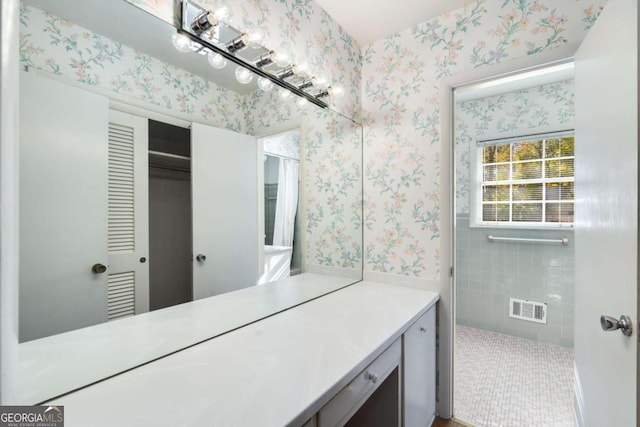 bathroom with tile patterned flooring and vanity