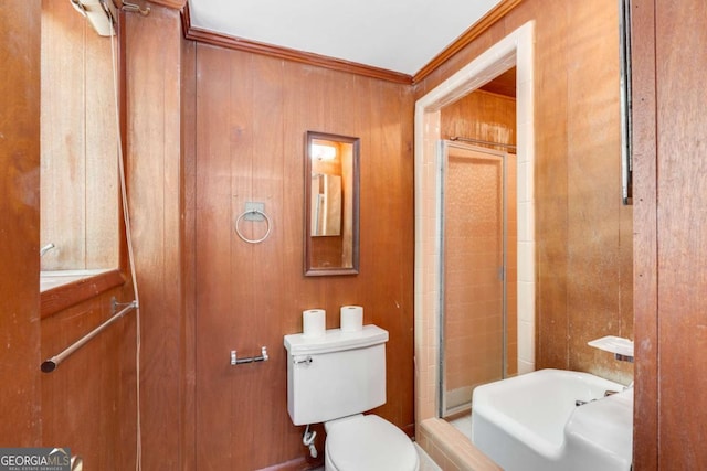 bathroom featuring crown molding, walk in shower, wood walls, and toilet