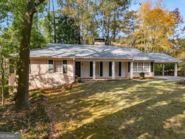 ranch-style home with a carport, a porch, and a front lawn