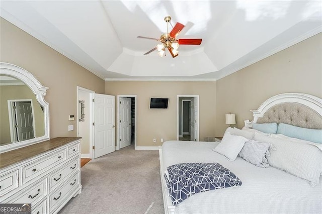 bedroom with crown molding, light carpet, ceiling fan, and a tray ceiling