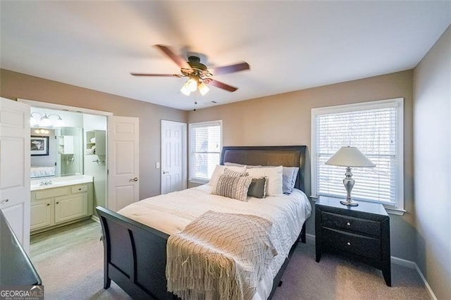 carpeted bedroom featuring connected bathroom and ceiling fan