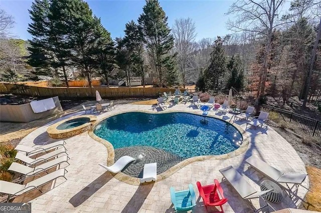 view of swimming pool with an in ground hot tub and a patio