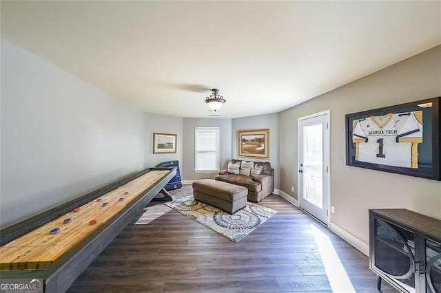 sitting room with dark wood-type flooring