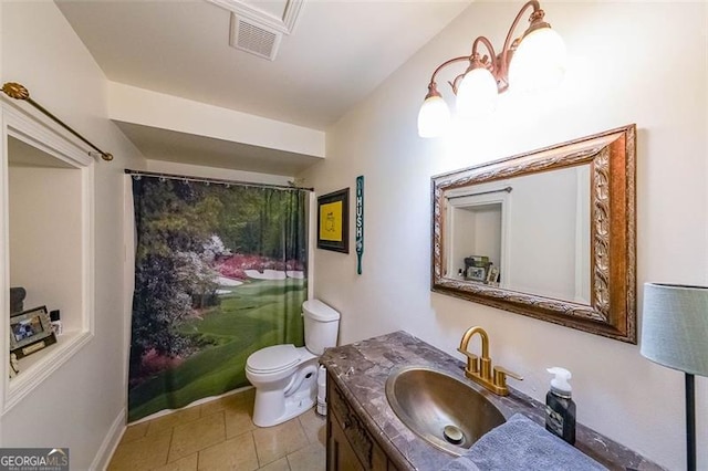 bathroom with tile patterned flooring, vanity, and toilet