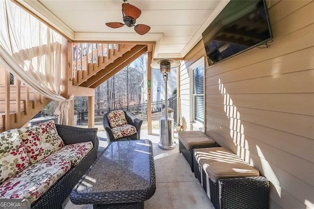 sunroom featuring ceiling fan