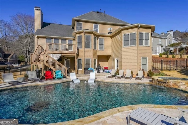 back of house with a pool with hot tub and a patio