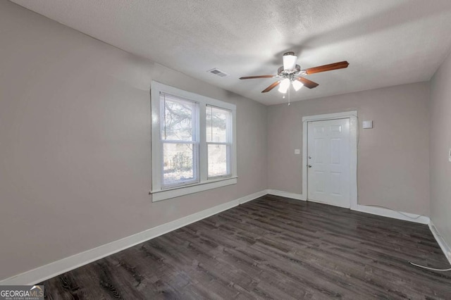 1333 Womack Ave, Atlanta, GA 30344 - unfurnished room featuring ceiling fan, dark wood-type flooring, and a textured ceiling