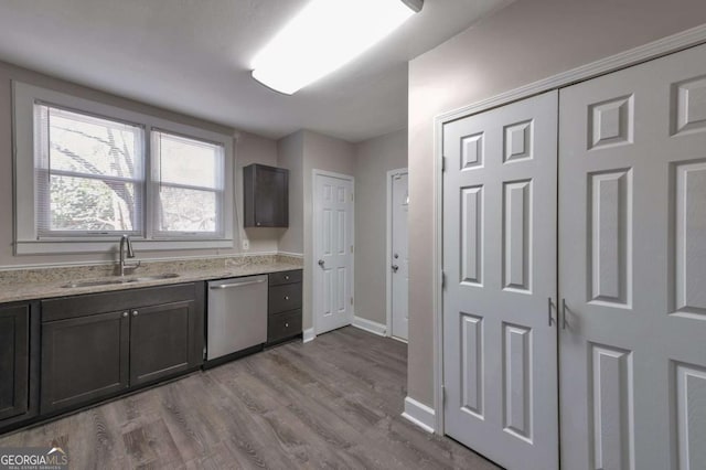 1333 Womack Ave, Atlanta, GA 30344 - kitchen with dishwasher, sink, light stone counters, light hardwood / wood-style floors, and dark brown cabinets