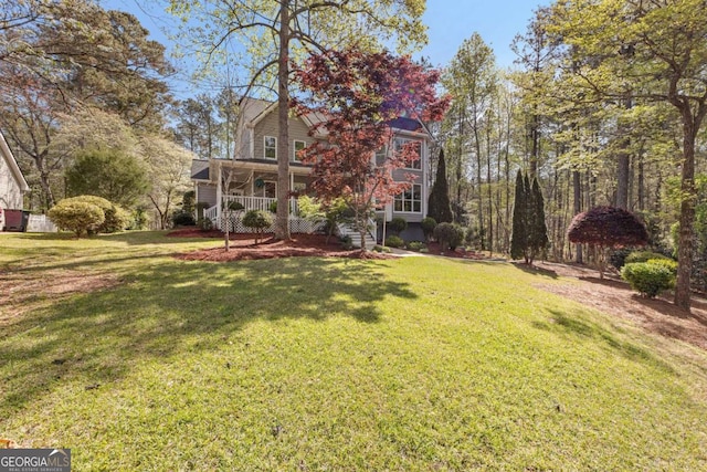 view of yard featuring covered porch