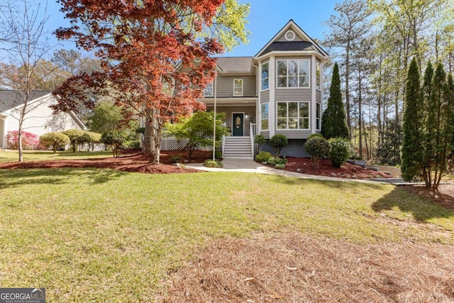 victorian house featuring a front yard