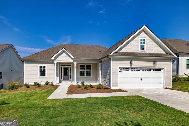 view of front of home featuring a porch, a garage, and a front lawn