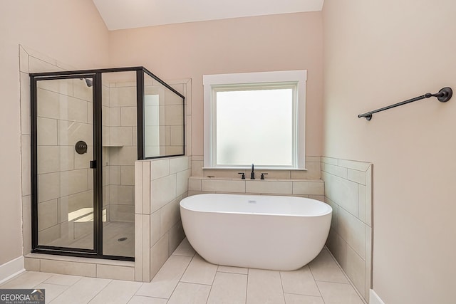 bathroom featuring independent shower and bath and tile patterned flooring