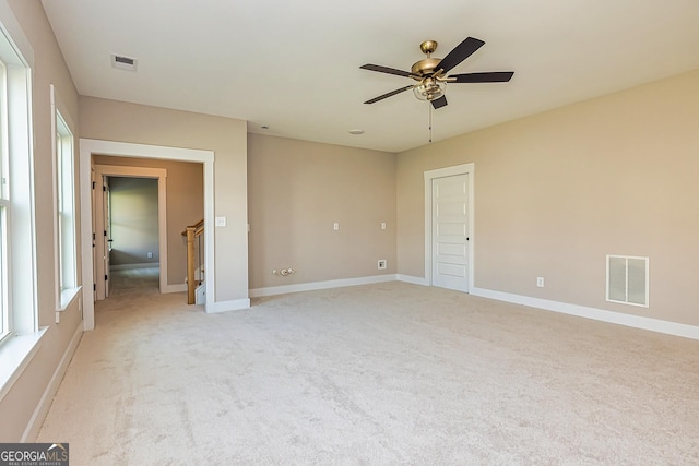 carpeted empty room featuring ceiling fan