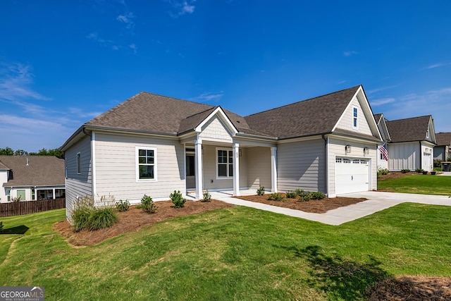 view of front of house featuring a porch, a garage, and a front yard