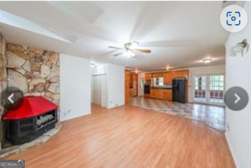 living room featuring ceiling fan and light hardwood / wood-style floors