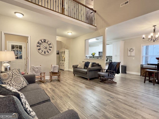 living room with an inviting chandelier and wood-type flooring