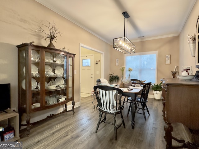 dining room featuring crown molding and dark wood-type flooring