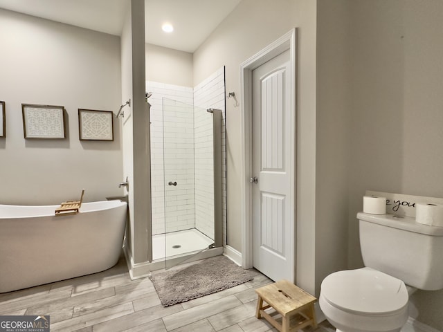 bathroom featuring toilet and separate shower and tub