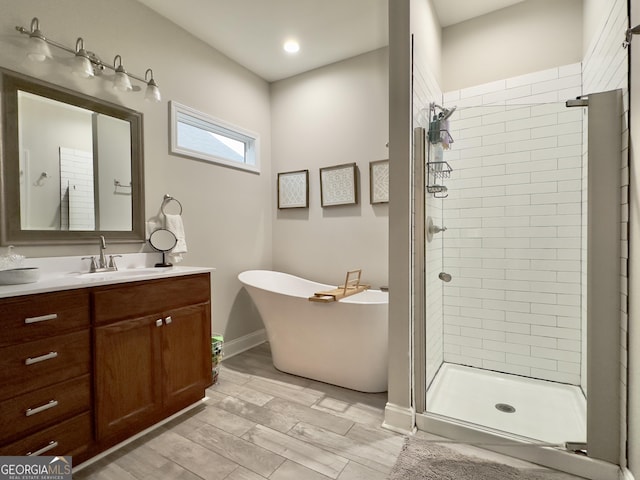 bathroom with vanity and independent shower and bath