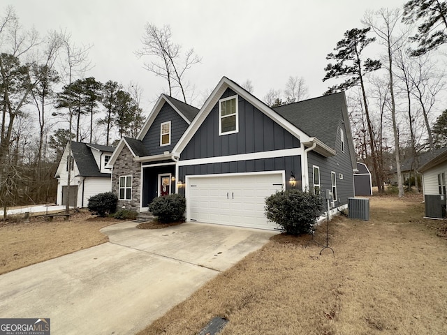 view of front of home featuring a garage and cooling unit