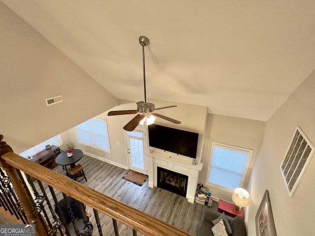 living room featuring vaulted ceiling, hardwood / wood-style floors, and ceiling fan