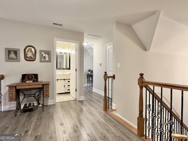 hall with hardwood / wood-style floors