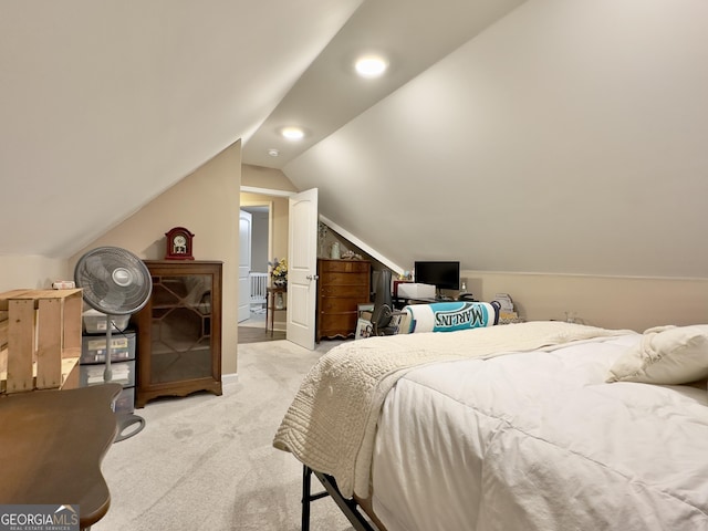 bedroom featuring lofted ceiling and light carpet