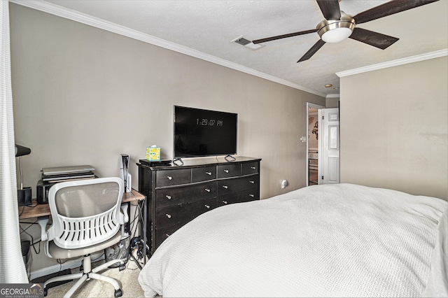 bedroom with ceiling fan, ornamental molding, and a textured ceiling